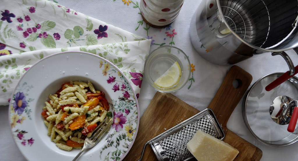 Home-made pasta with tomatoes and pine nuts